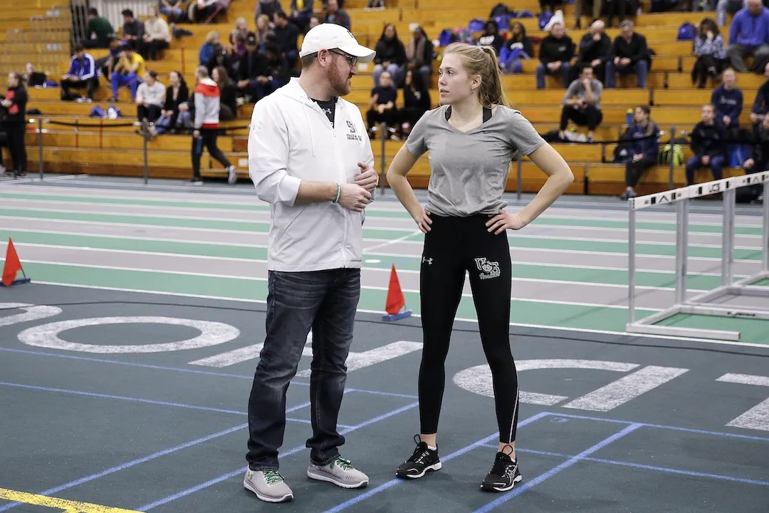 A college coach talking with an athlete